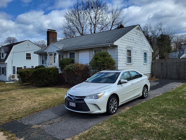 24 Neillian Cres, Boston, MA 02130 - view of front of house with a chimney, roof with shingles, and asphalt driveway
