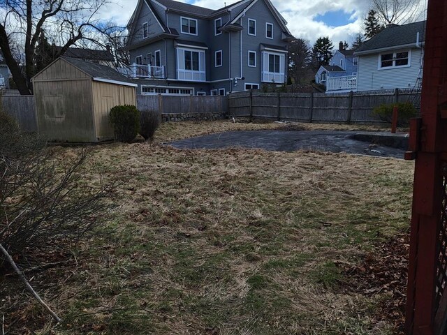 24 Neillian Cres, Boston, MA 02130 - view of yard featuring a storage unit, fence, and an outdoor structure