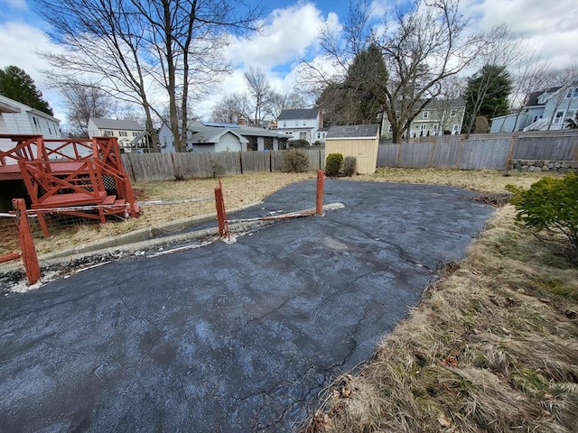 24 Neillian Cres, Boston, MA 02130 - fenced backyard with a shed, an outdoor structure, a residential view, and a wooden deck