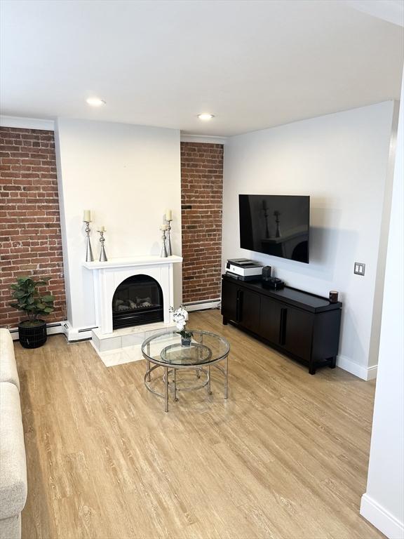 living room featuring hardwood / wood-style floors and a fireplace