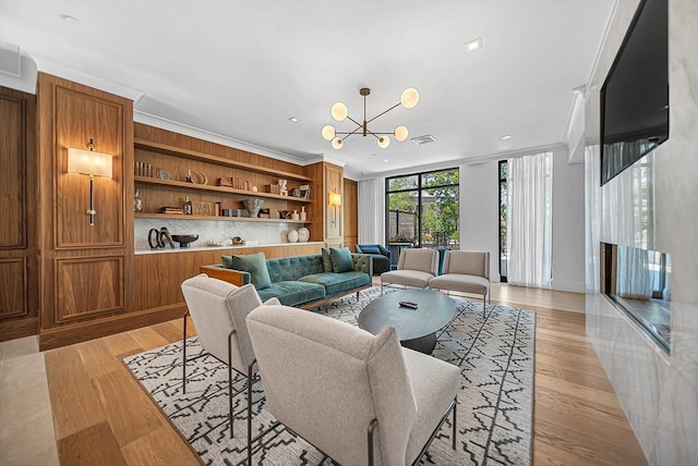191 Washington St Unit 318, Boston, MA 02135 - living room featuring a chandelier, light wood-style flooring, and crown molding
