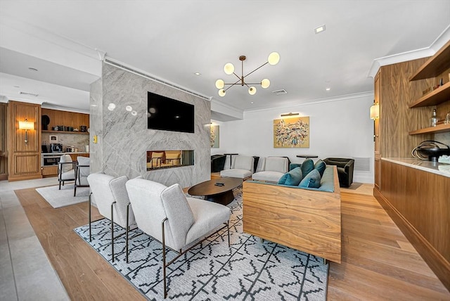191 Washington St Unit 318, Boston, MA 02135 - living area with a fireplace, light wood-type flooring, ornamental molding, and a chandelier