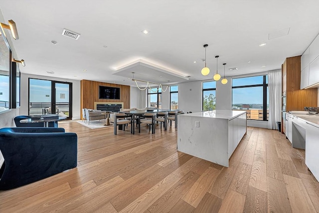 191 Washington St Unit 318, Boston, MA 02135 - kitchen featuring modern cabinets, a spacious island, open floor plan, white cabinets, and recessed lighting