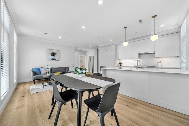 191 Washington St Unit 318, Boston, MA 02135 - dining space featuring healthy amount of natural light, ornamental molding, recessed lighting, light wood-style flooring, and baseboards