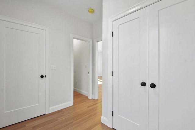 unfurnished bedroom with light hardwood / wood-style flooring and a closet