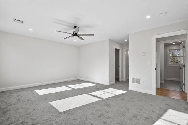 carpeted spare room with ceiling fan