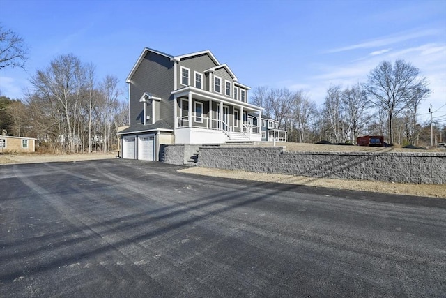 view of front facade with a garage and covered porch