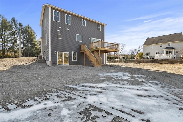 snow covered property with a wooden deck