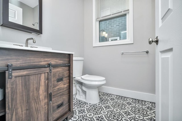 bathroom featuring toilet, vanity, and tile patterned floors