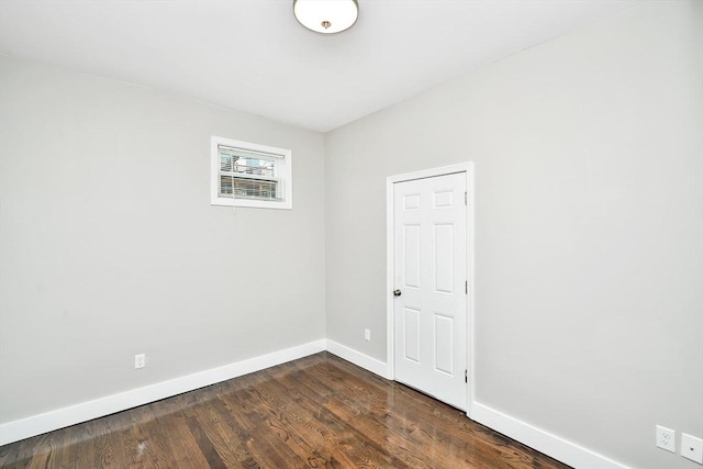 empty room with dark wood-type flooring