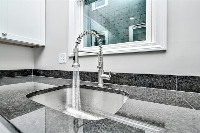 room details with white cabinets and sink