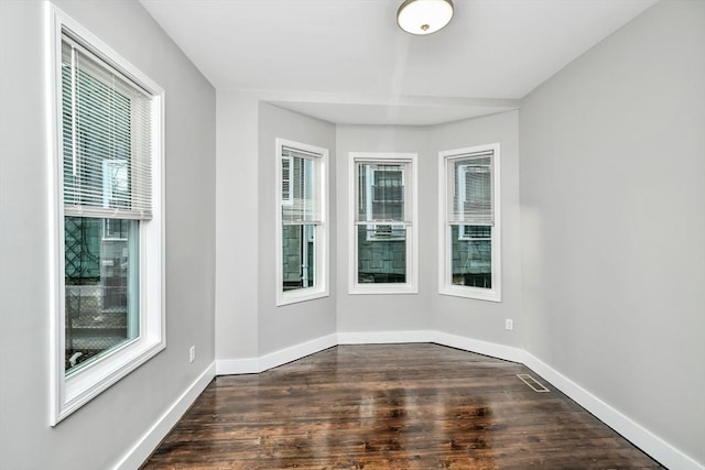 unfurnished room with dark hardwood / wood-style floors