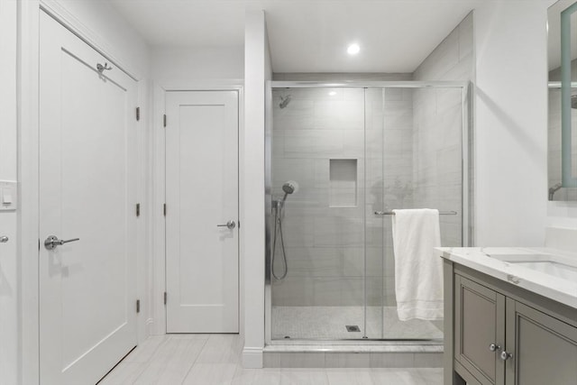 bathroom featuring vanity and an enclosed shower