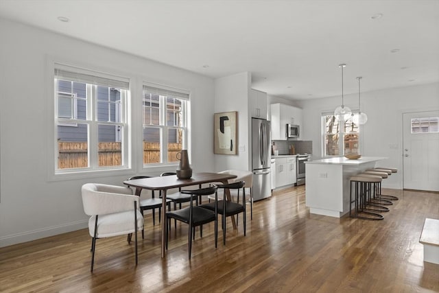 dining space with dark hardwood / wood-style floors