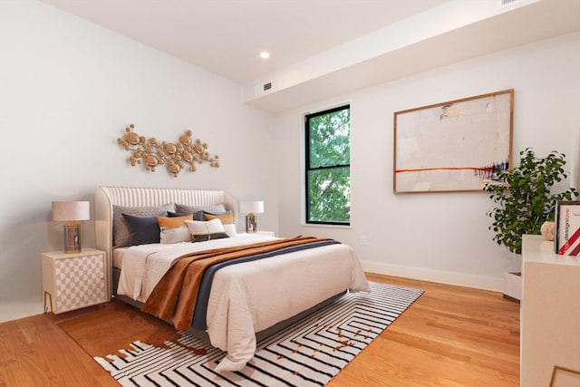 bedroom with hardwood / wood-style floors