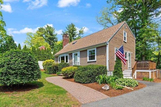 30 Linda Rd, Wilmington, MA 01887 - view of front facade featuring a chimney, a shingled roof, a deck, and a front yard