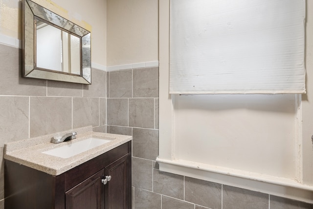 bathroom with vanity, tile walls, and tasteful backsplash