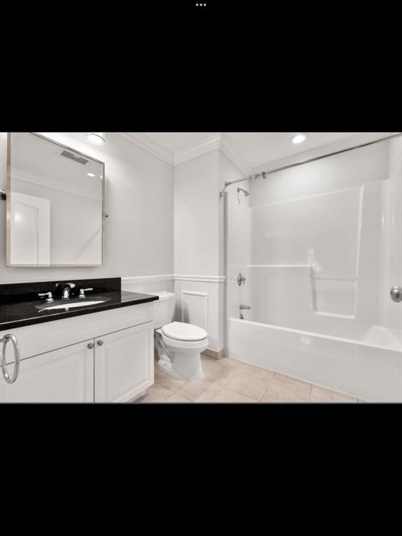 full bath with toilet, crown molding, vanity, shower / bathtub combination, and tile patterned floors