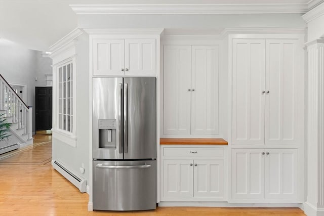 kitchen with stainless steel refrigerator with ice dispenser, white cabinetry, crown molding, a baseboard radiator, and light hardwood / wood-style floors