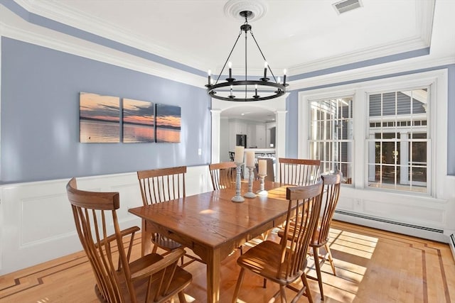 dining area with crown molding, light hardwood / wood-style floors, ornate columns, and baseboard heating