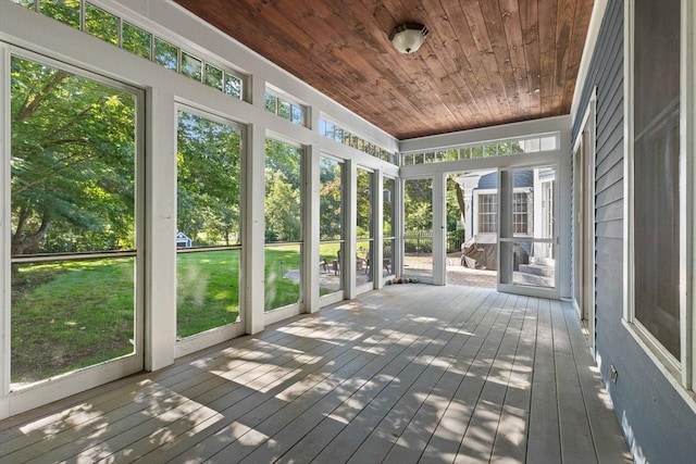 unfurnished sunroom featuring wooden ceiling and a healthy amount of sunlight