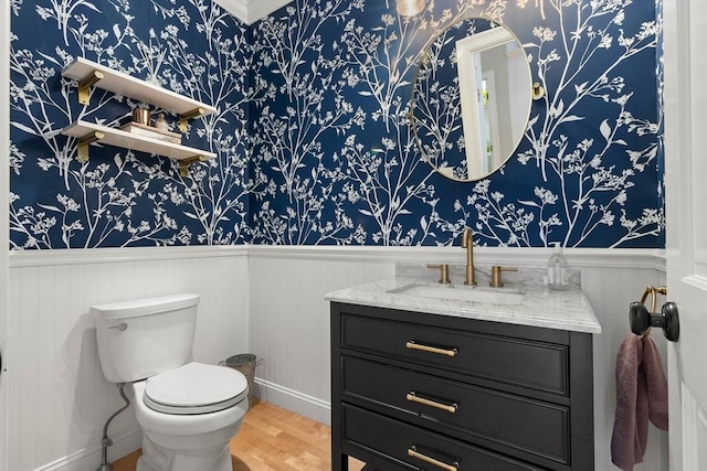 bathroom featuring hardwood / wood-style flooring, vanity, and toilet