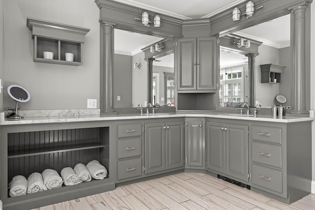 bathroom featuring vanity, ornamental molding, and ornate columns