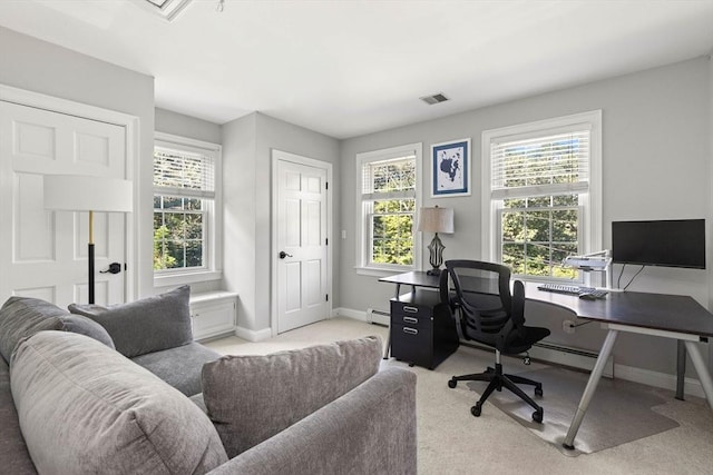 carpeted office with a baseboard radiator