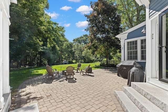 view of patio with a grill and a fire pit