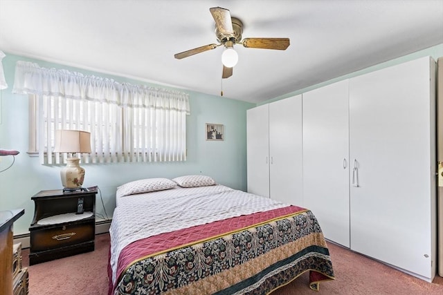 bedroom featuring ceiling fan, a closet, a baseboard radiator, and light colored carpet