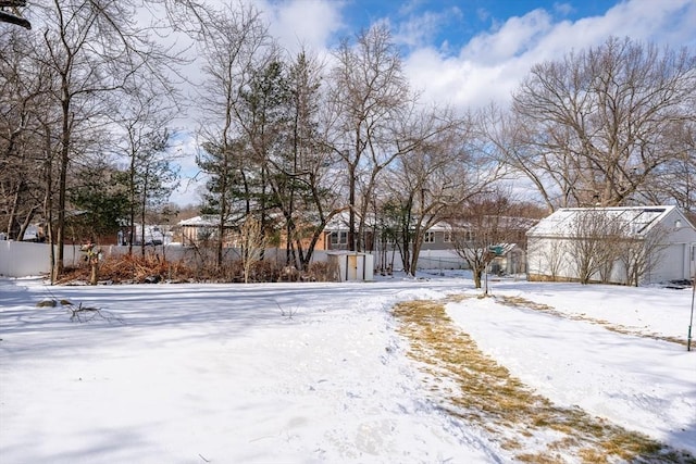 yard covered in snow with a residential view