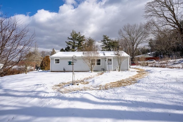 view of snow covered rear of property