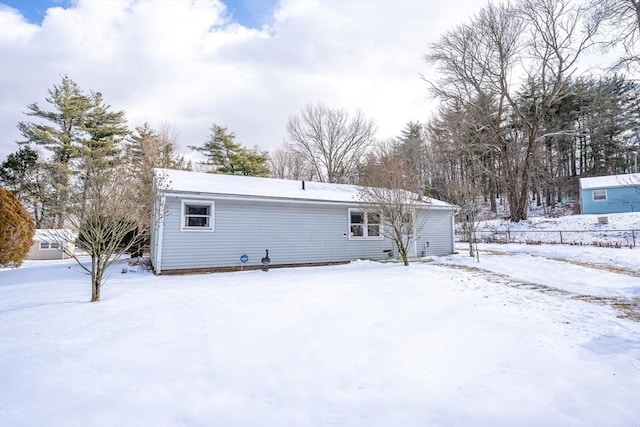 view of snow covered rear of property