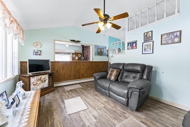 living room featuring ceiling fan, a baseboard radiator, vaulted ceiling, and wood finished floors