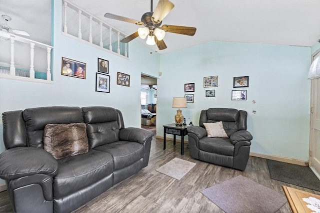 living room with lofted ceiling, wood finished floors, a ceiling fan, and baseboards