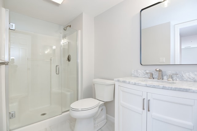 bathroom featuring vanity, toilet, and a shower with door