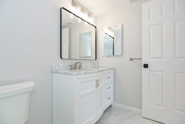 bathroom featuring vanity and toilet