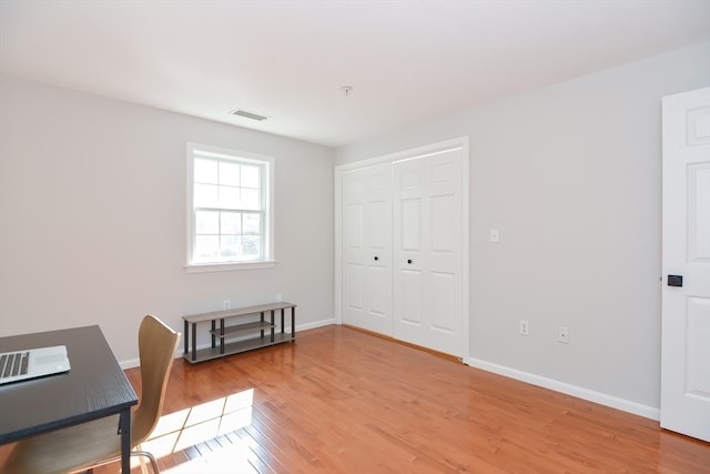 unfurnished office featuring hardwood / wood-style floors