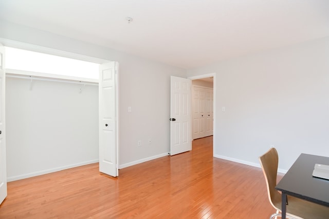 unfurnished office featuring hardwood / wood-style floors