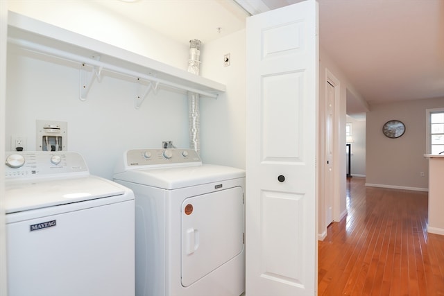 washroom with light wood-type flooring and washing machine and dryer