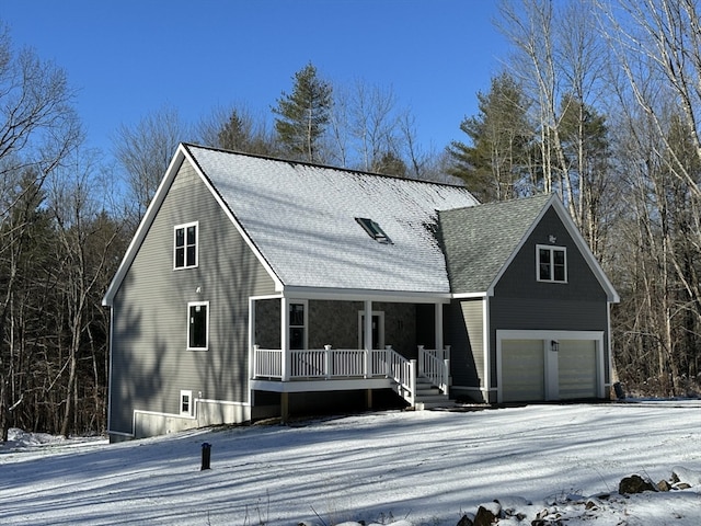 view of front of property with covered porch and a garage