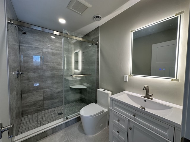 bathroom featuring tile patterned floors, vanity, toilet, and an enclosed shower