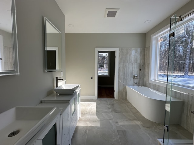 bathroom with a bath and vanity