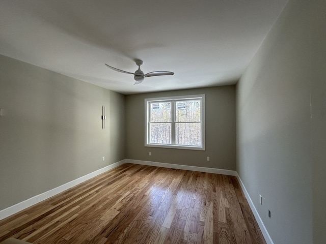 empty room with ceiling fan and light hardwood / wood-style floors