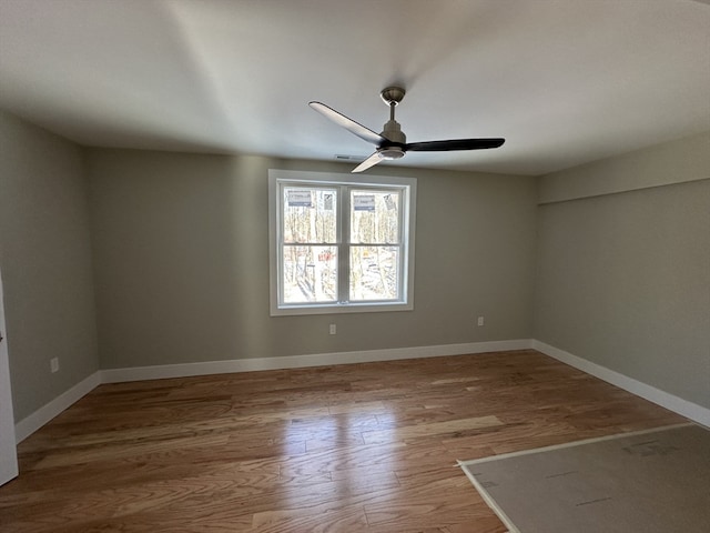 unfurnished room featuring ceiling fan and hardwood / wood-style flooring