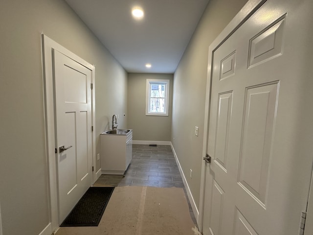 hall featuring dark wood-type flooring and sink