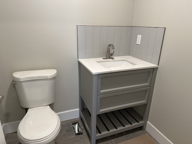 bathroom with tile patterned flooring, vanity, and toilet