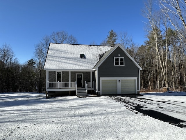 view of front of property featuring covered porch and a garage