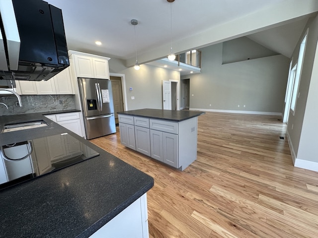 kitchen featuring white cabinets, sink, stainless steel refrigerator with ice dispenser, light hardwood / wood-style floors, and a kitchen island