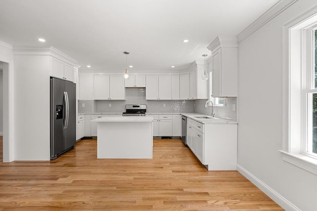 13 River Unit 2, Danvers, MA 01923 - kitchen featuring appliances with stainless steel finishes, a center island, light countertops, decorative backsplash, and recessed lighting